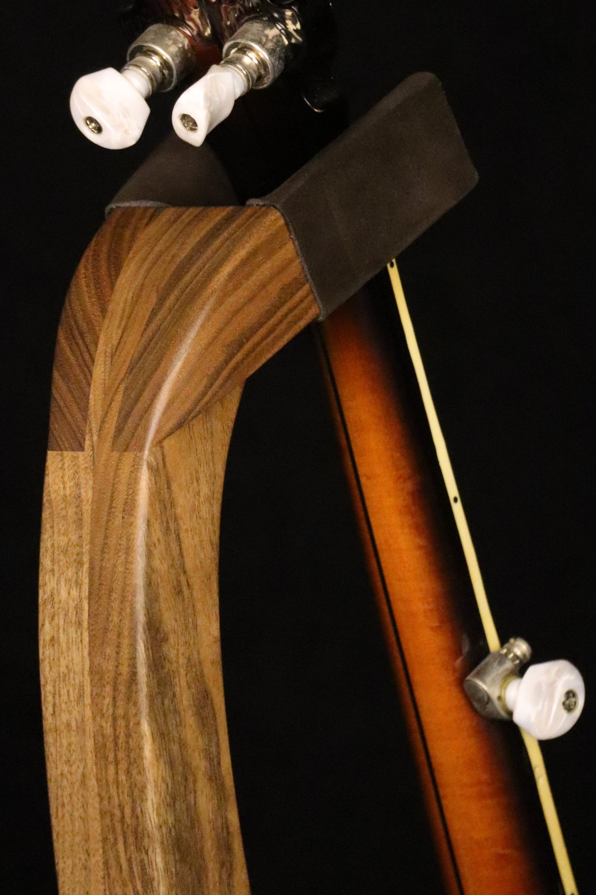 Folding walnut wood banjo floor stand yoke detail image with Alvarez banjo