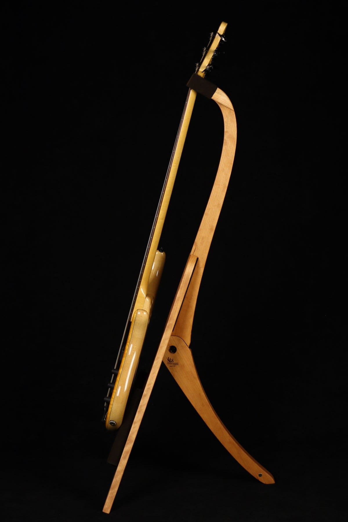 Folding cherry wood electric bass guitar floor stand full side image with Pedulla 6 string fretless bass