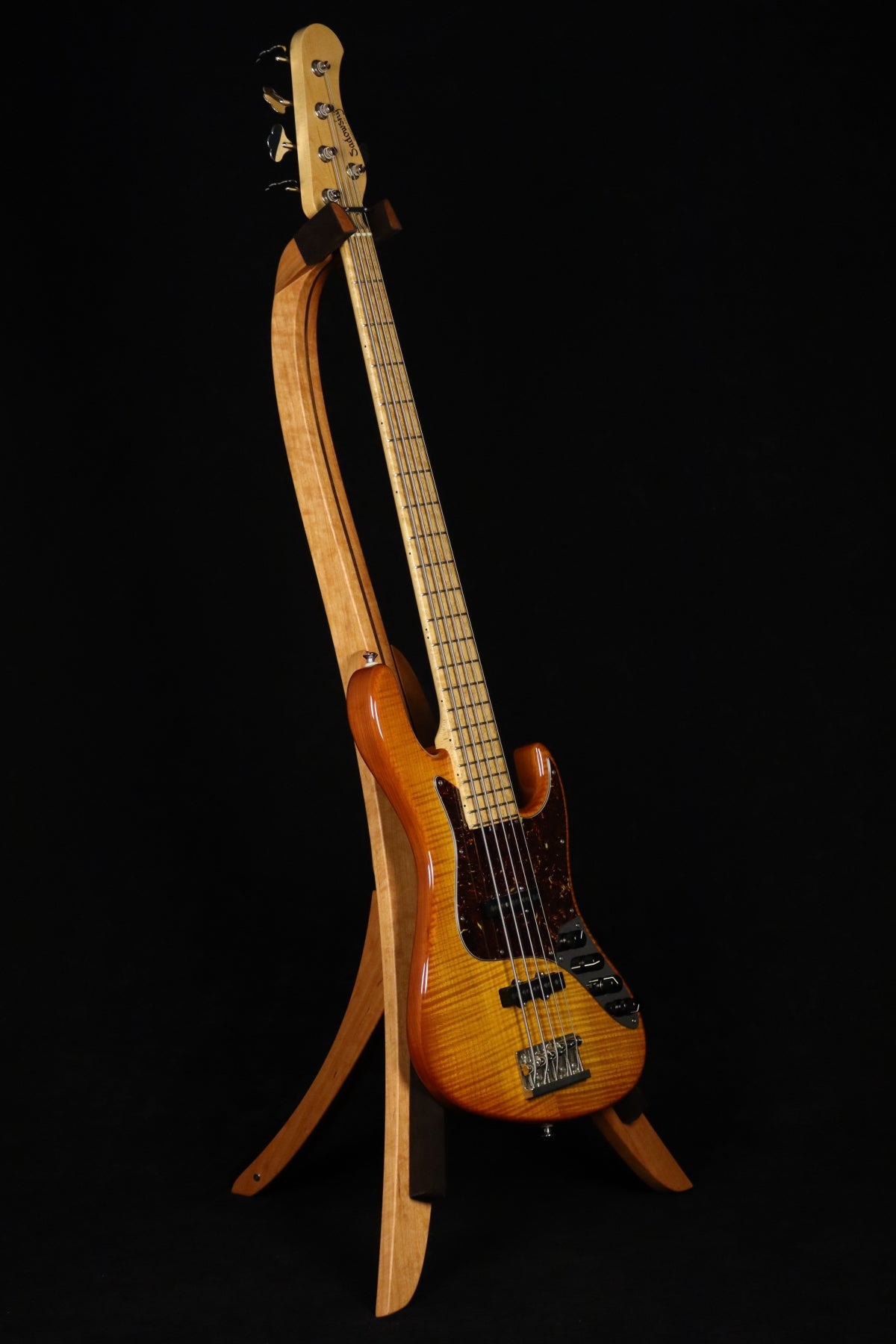 Folding cherry and walnut wood electric bass guitar floor stand full front image with Sadowsky 5 string bass