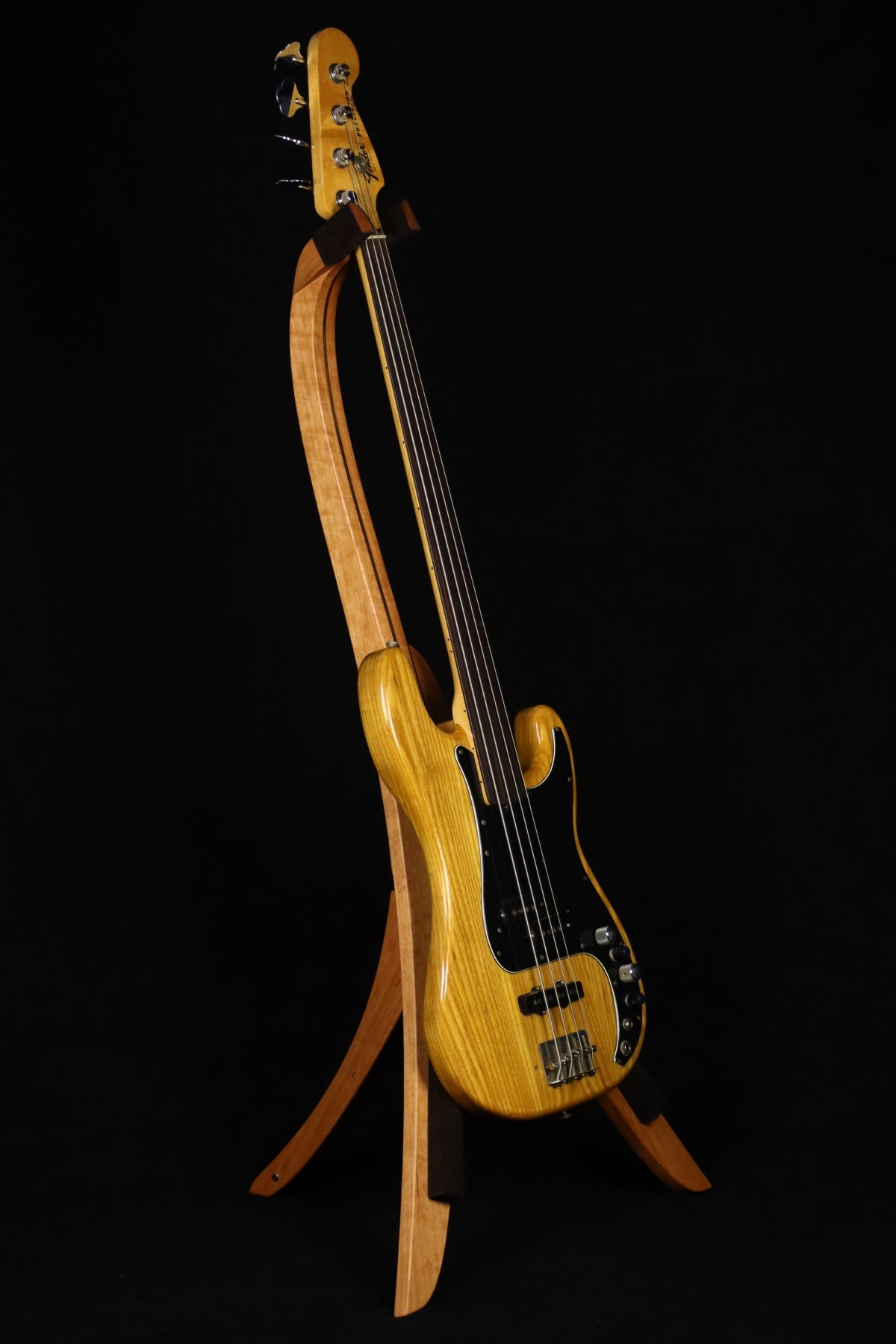 Folding cherry and walnut wood electric bass guitar floor stand full front image with Fender Precision 4 string fretless bass