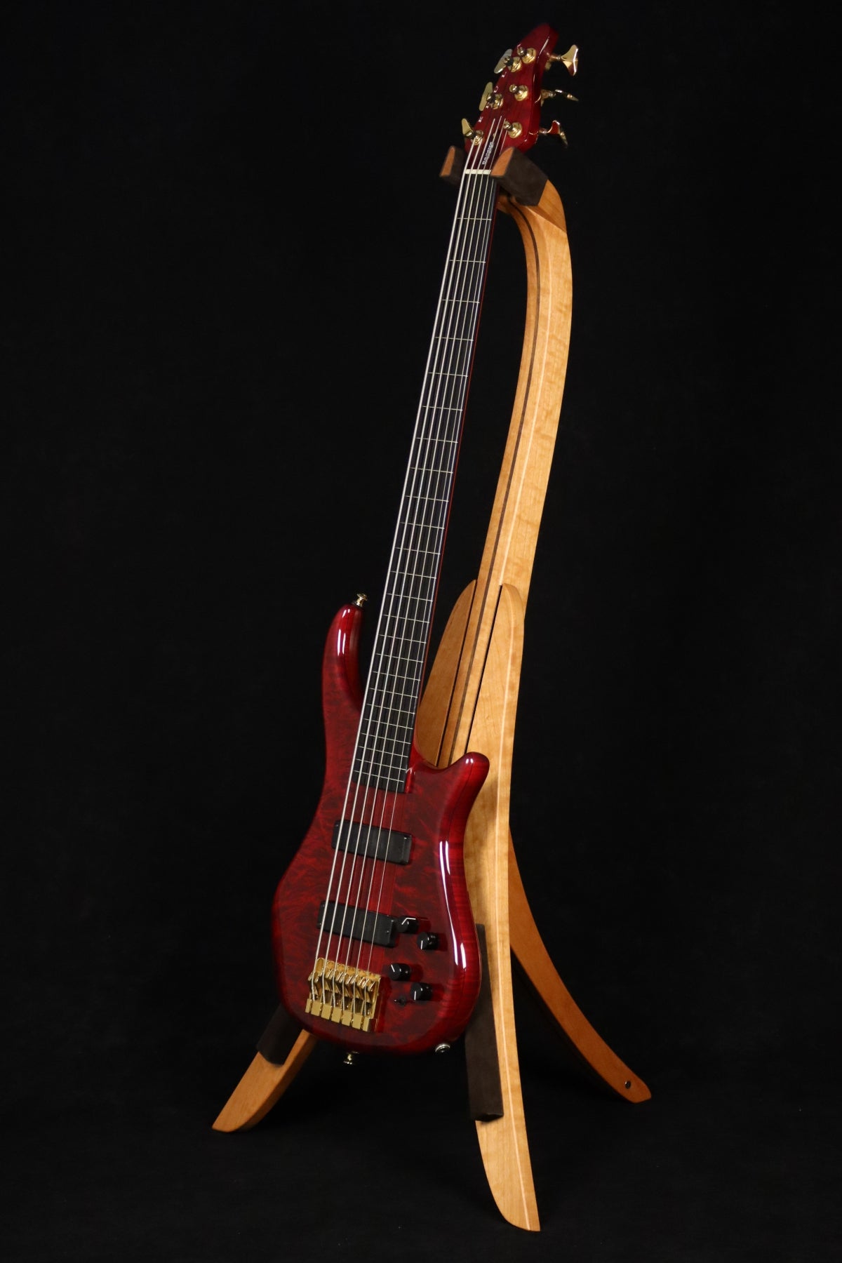 Folding cherry and walnut wood electric bass guitar floor stand full front image with Pedulla 6 string fretless bass
