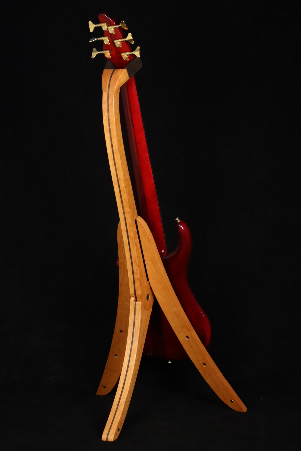 Folding cherry and walnut wood electric bass guitar floor stand full rear image with Pedulla 6 string fretless bass