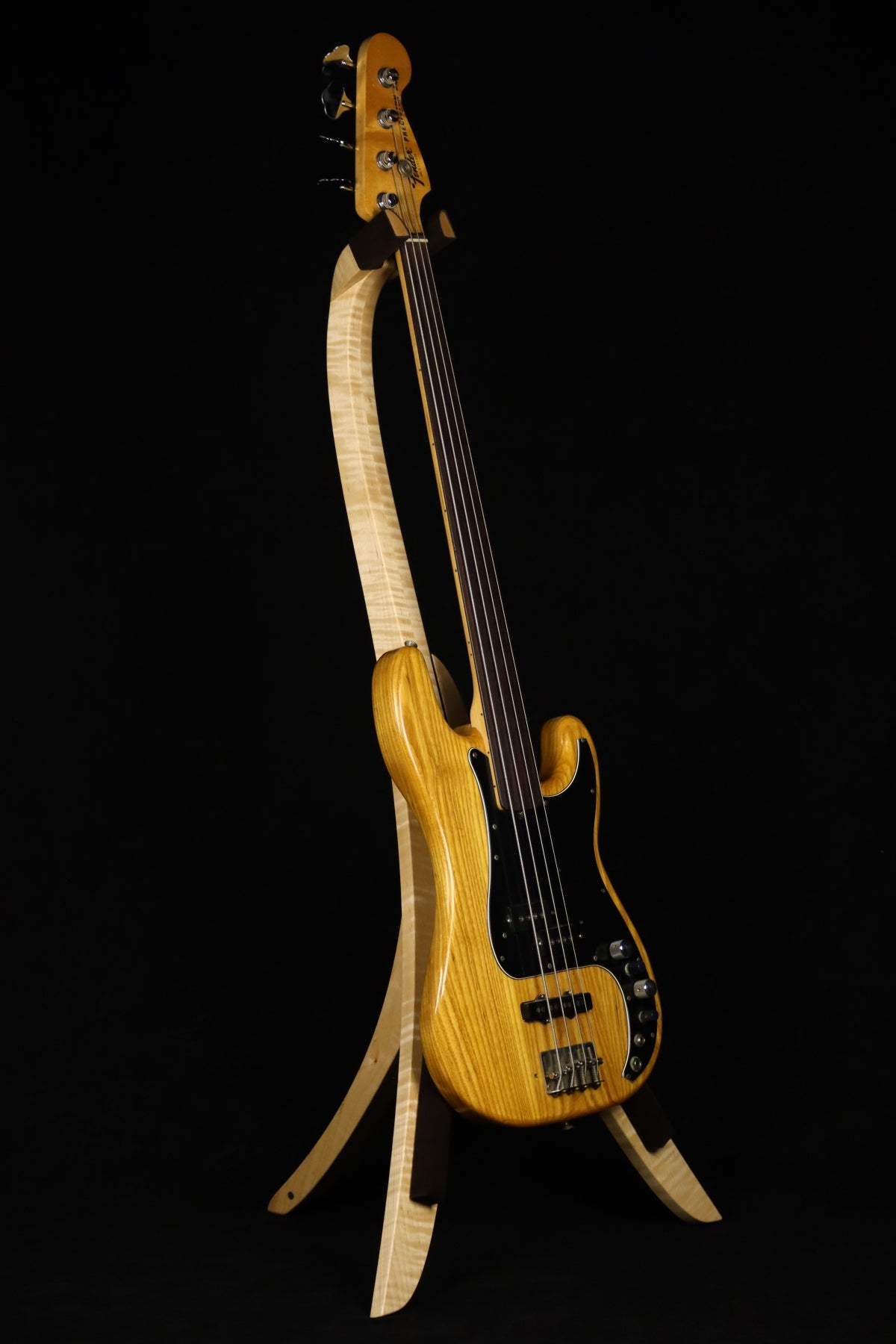 Folding curly maple wood electric bass guitar floor stand full front image with Fender Precision 4 string fretless bass