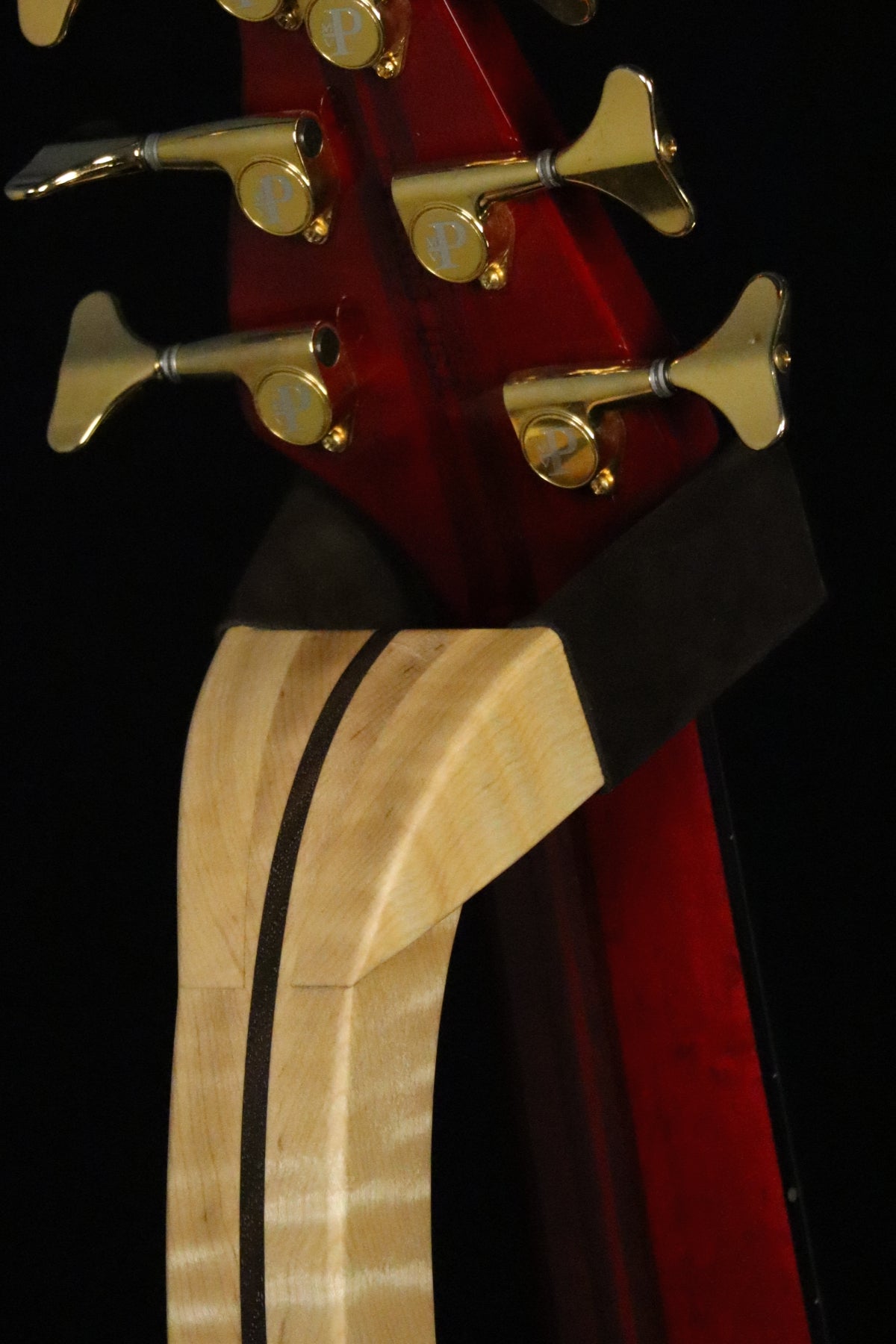 Folding curly maple and walnut wood electric bass guitar floor stand closeup yoke detail image