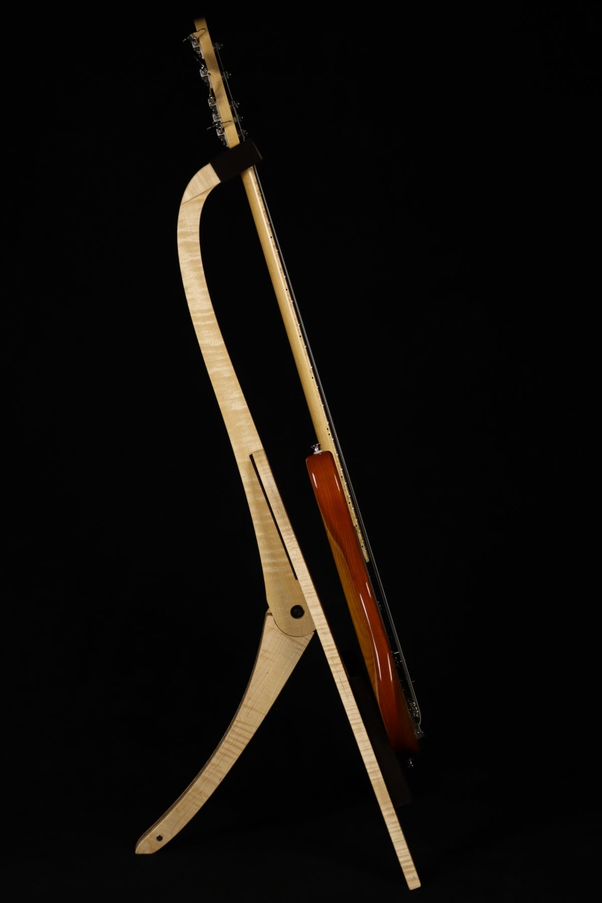 Folding curly maple and walnut wood electric bass guitar floor stand full side image with Sadowsky 5 string bass