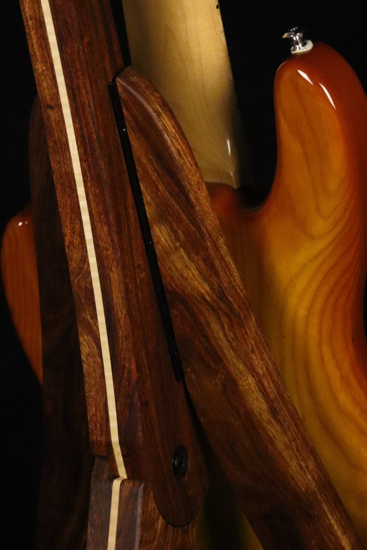 Folding chechen Caribbean rosewood and curly maple wood electric bass guitar floor stand closeup rear image