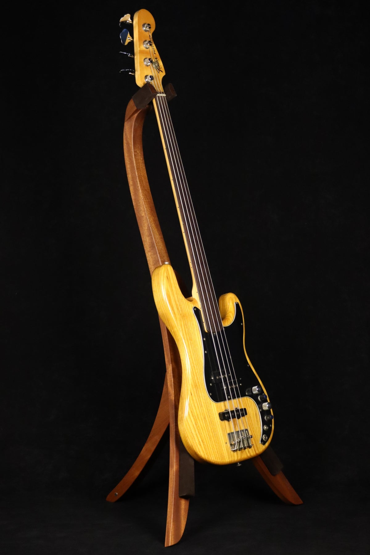 Folding sapele mahogany wood electric bass guitar floor stand full front image with Fender Precision 4 string fretless bass