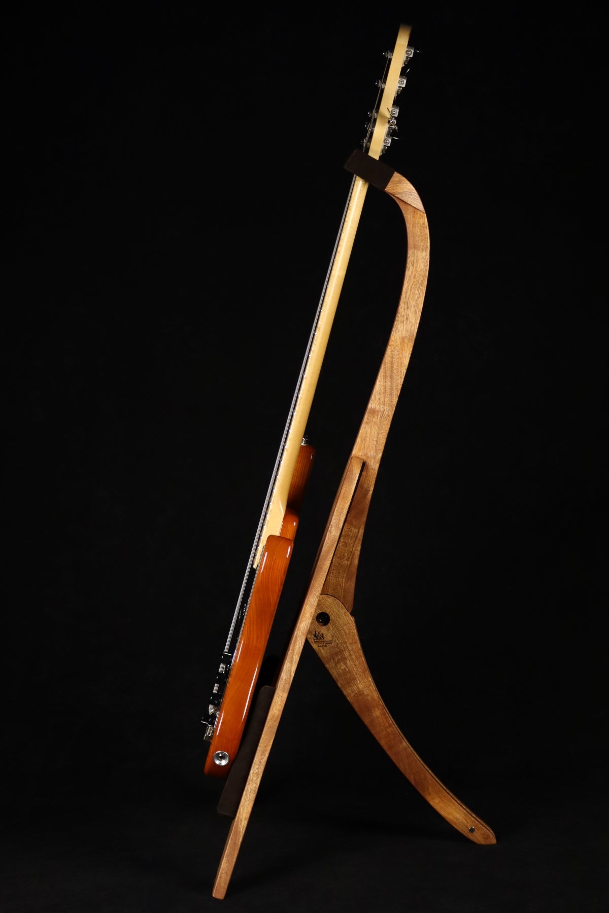 Folding sapele mahogany and curly maple wood electric bass guitar floor stand full side image with Sadowsky 5 string bass