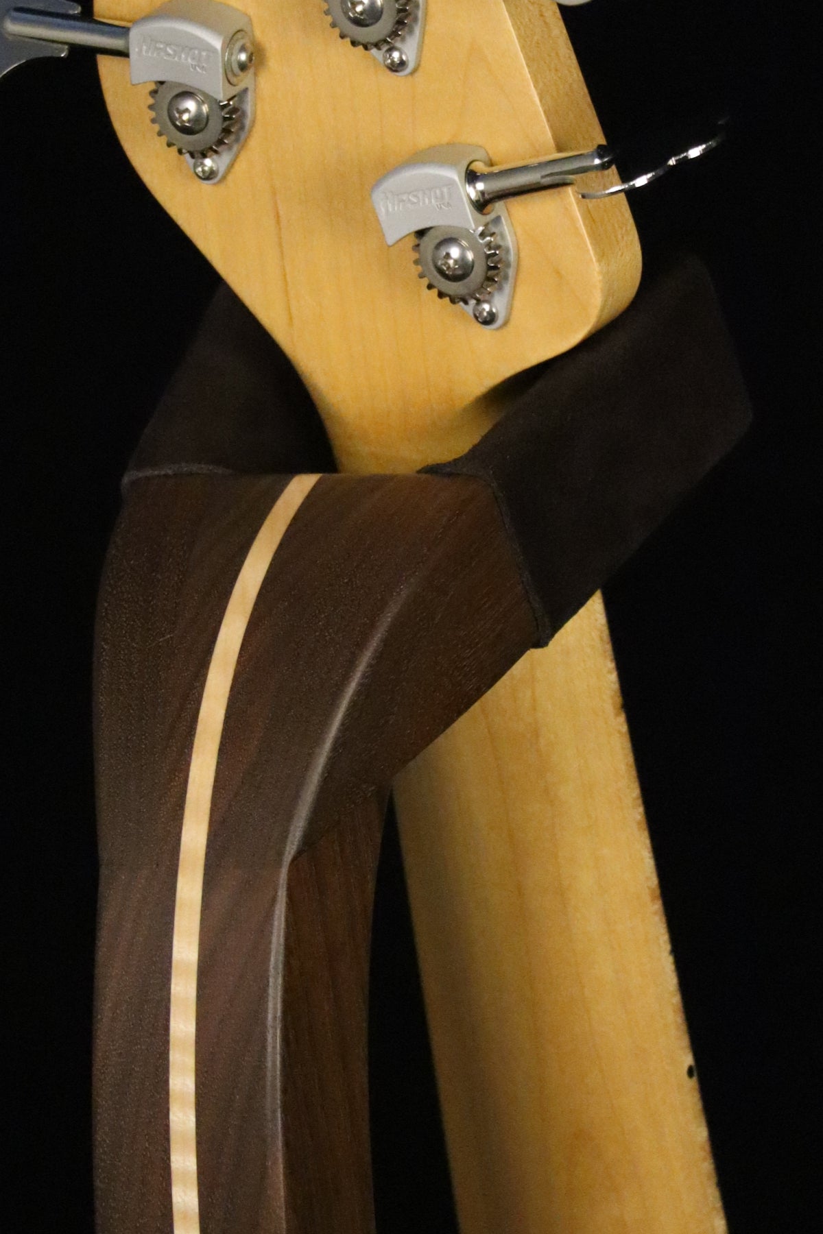 Folding walnut and curly maple wood electric bass guitar floor stand closeup yoke detail image