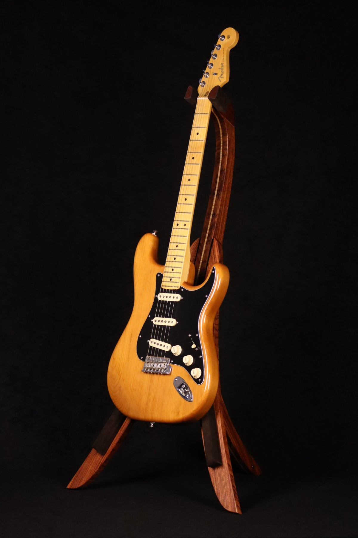 Folding bubinga rosewood and curly maple wood guitar floor stand full front image with Fender guitar
