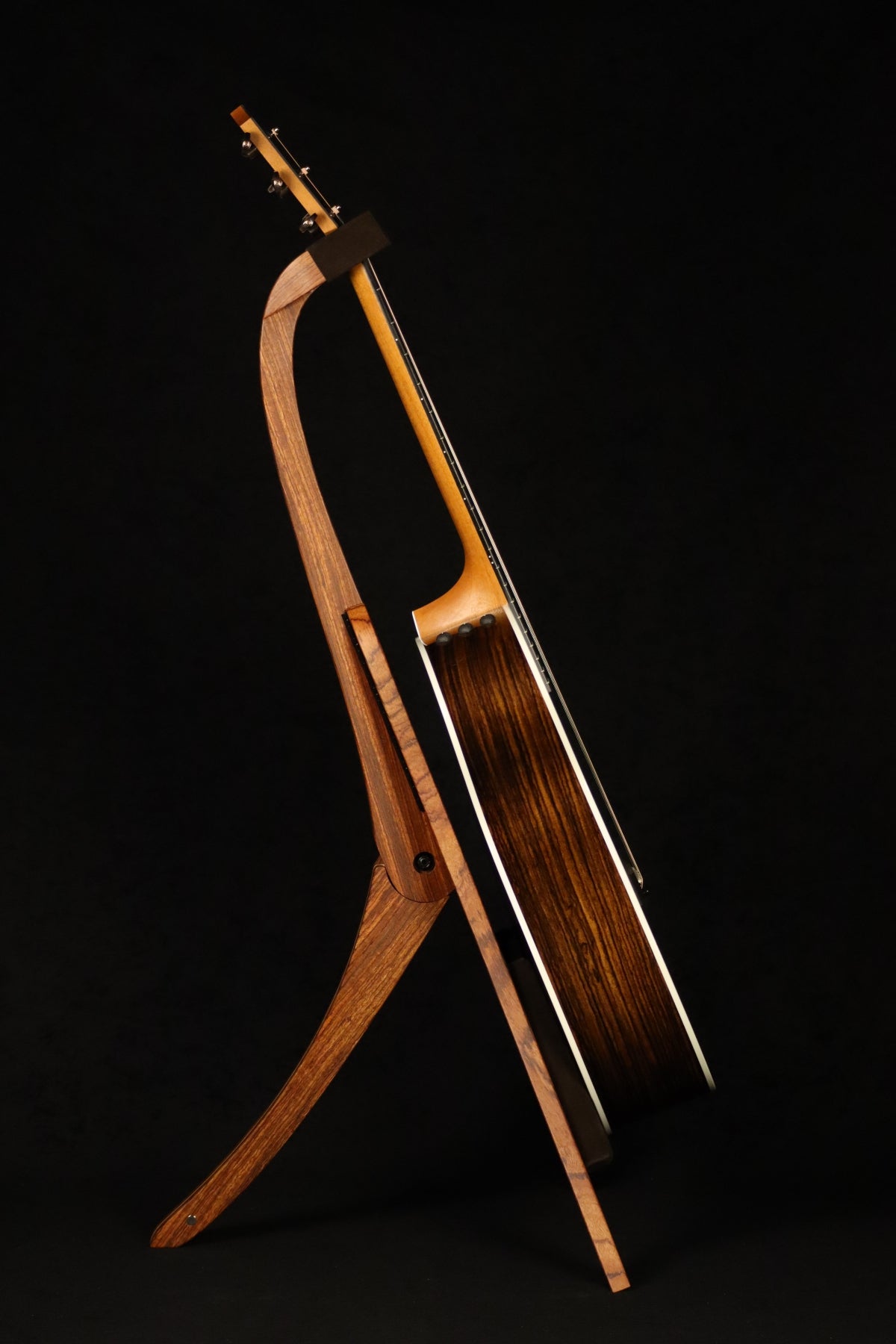 Folding bubinga rosewood and curly maple wood guitar floor stand full side image with Taylor guitar