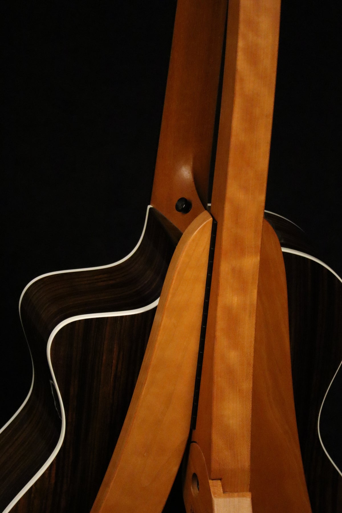 Folding cherry wood guitar floor stand closeup rear image with Taylor guitar