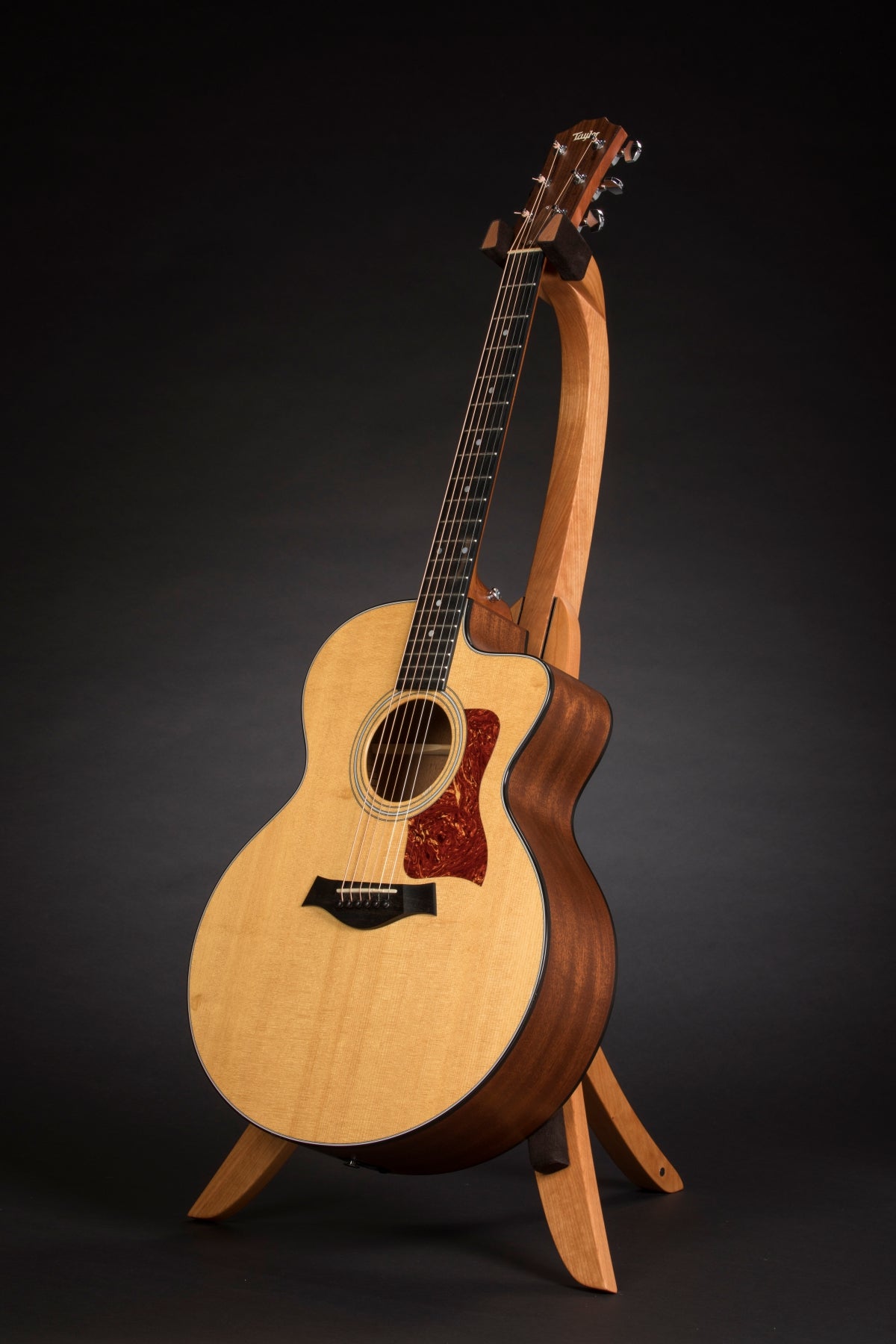 Folding cherry wood guitar floor stand full front image with Taylor guitar