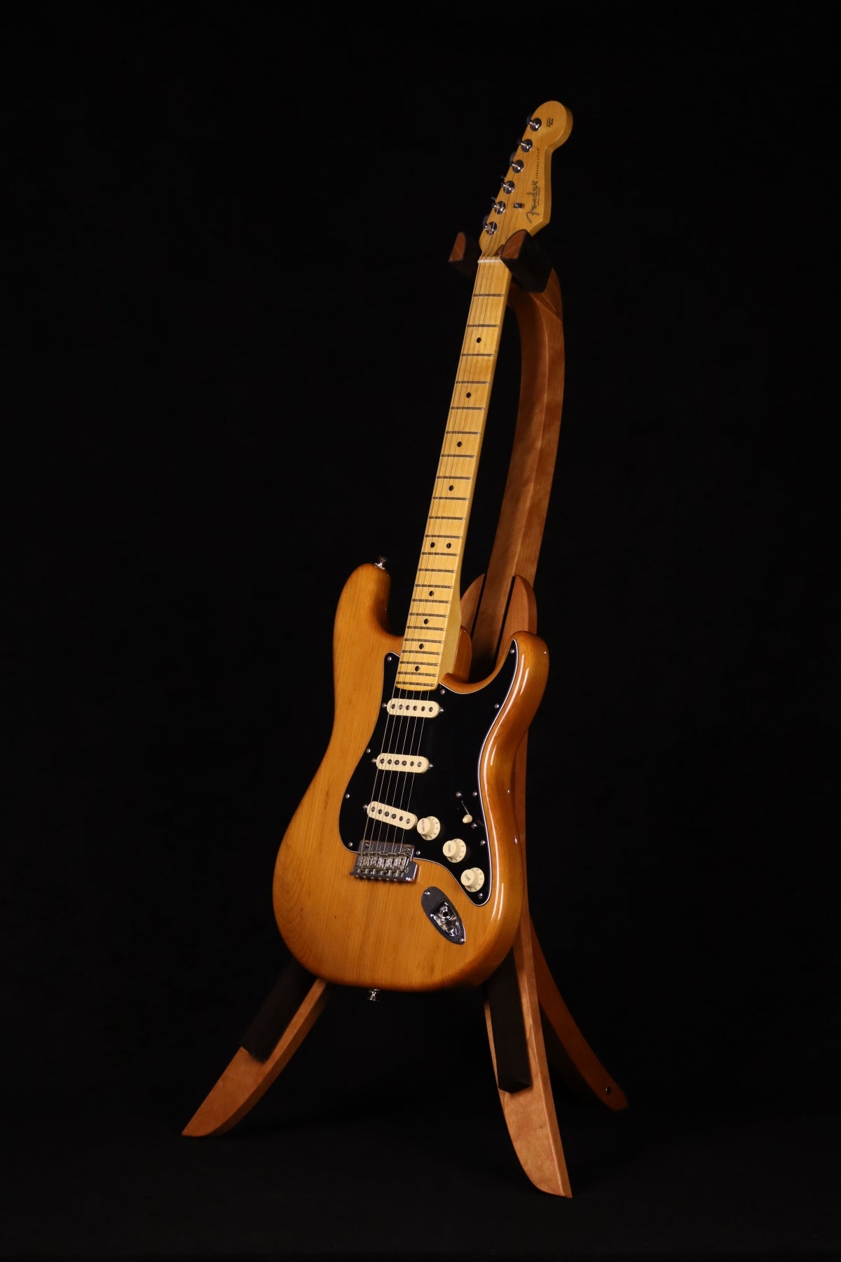 Folding cherry wood guitar floor stand full front image with Fender guitar