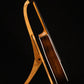 Folding cherry wood guitar floor stand full side image with Taylor guitar