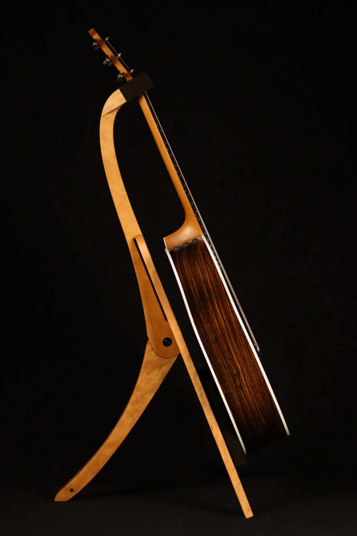 Folding cherry wood guitar floor stand full side image with Taylor guitar