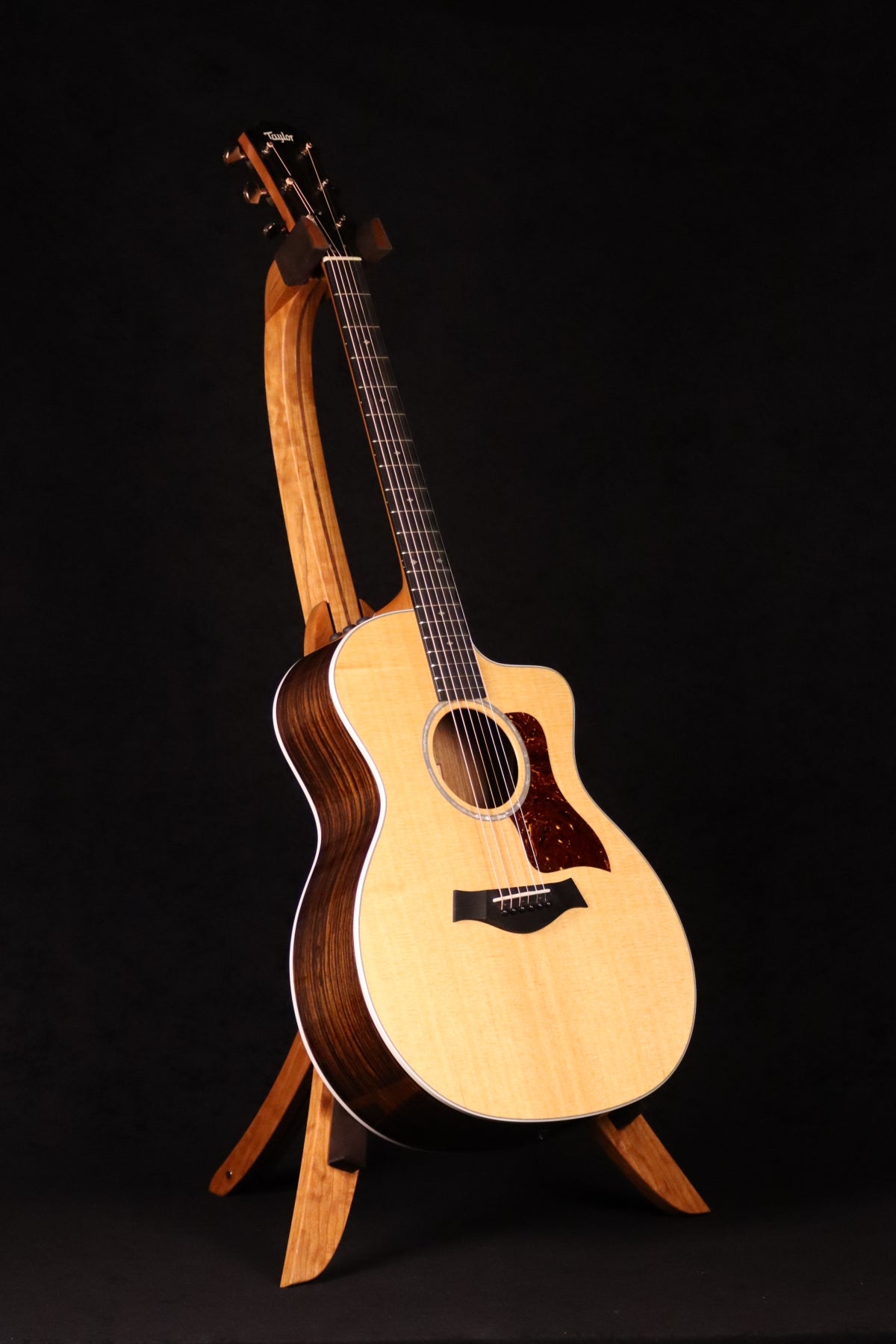 Folding cherry and walnut wood guitar floor stand full front image with Taylor guitar