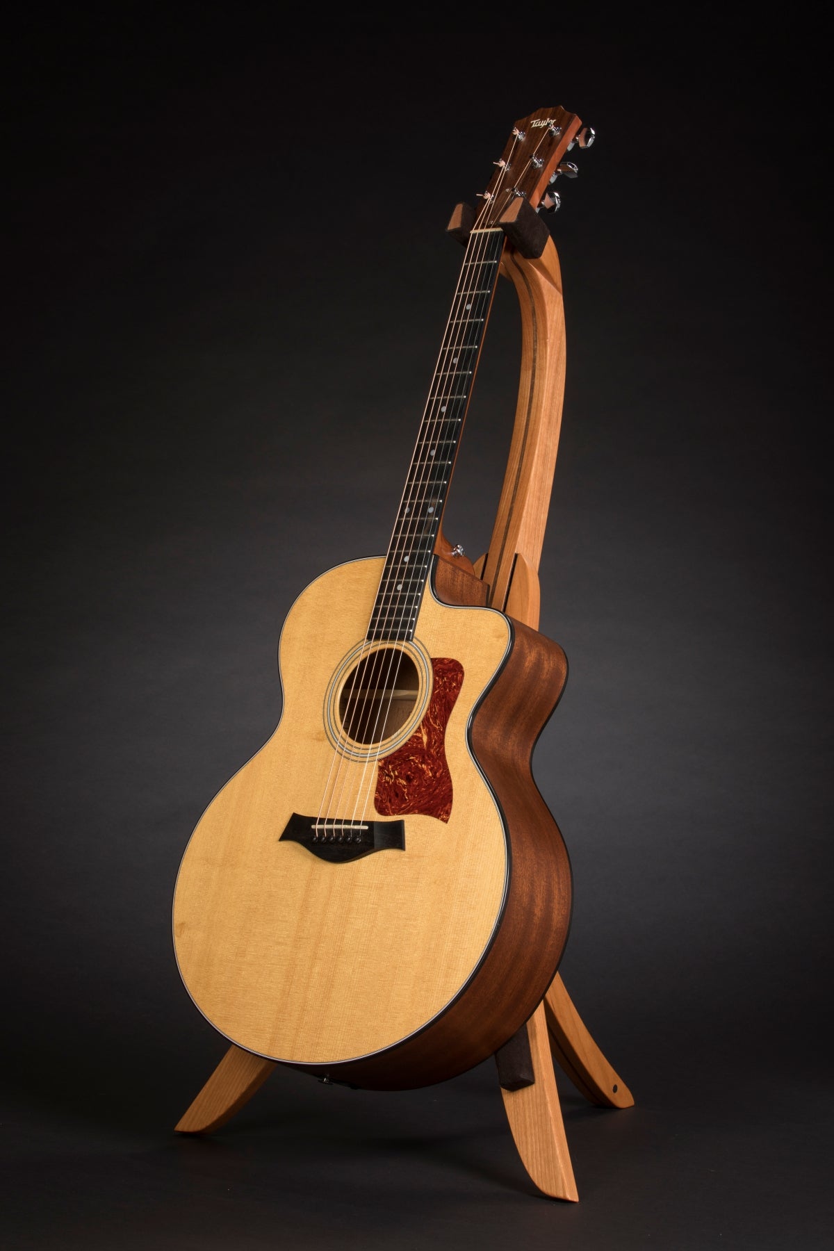 Folding cherry and walnut wood guitar floor stand full front image with Taylor guitar