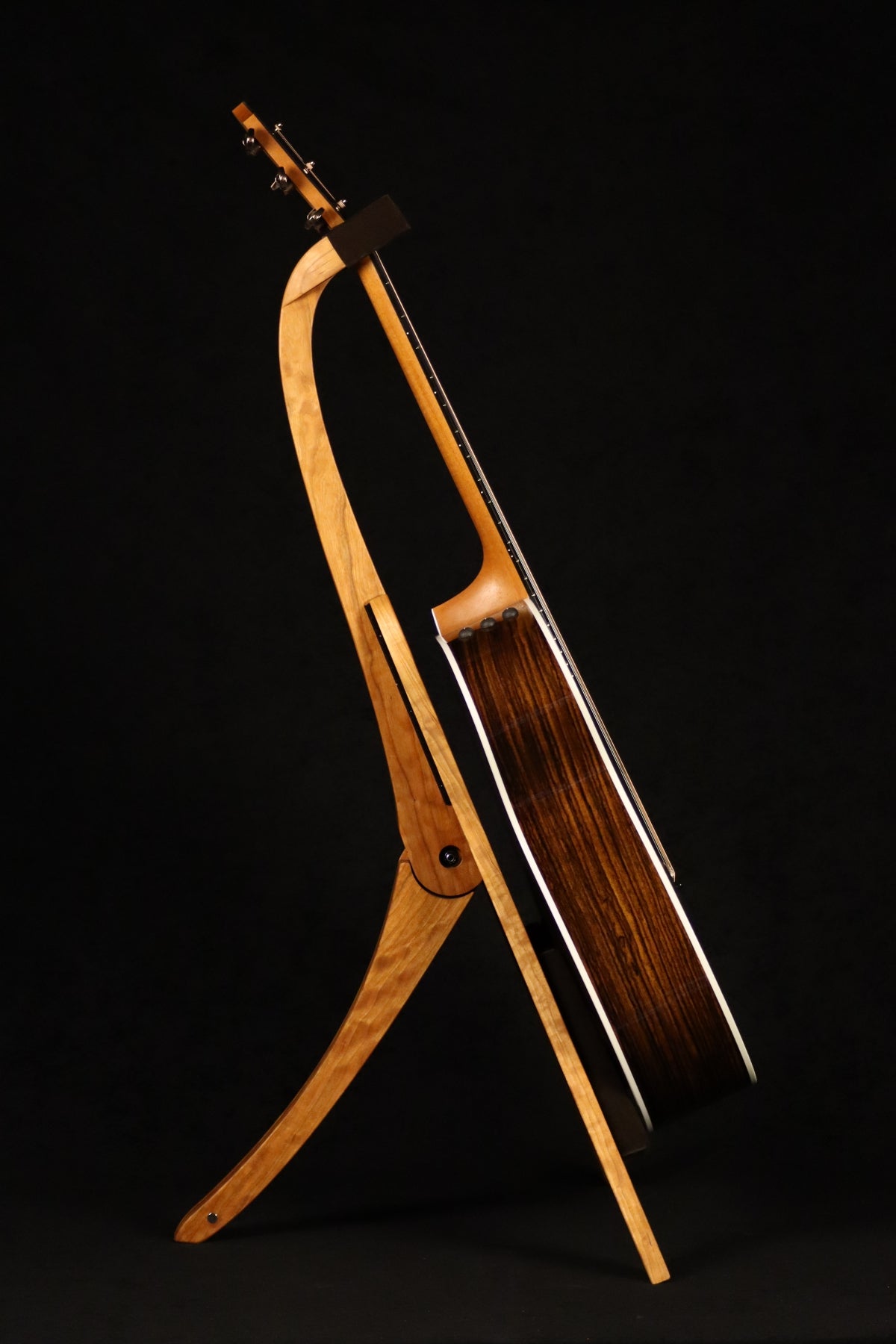 Folding cherry and walnut wood guitar floor stand full side image with Taylor guitar