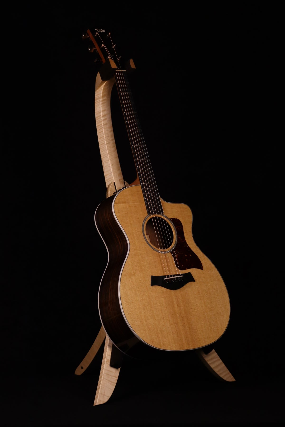 Folding curly maple wood guitar floor stand full front image with Taylor guitar