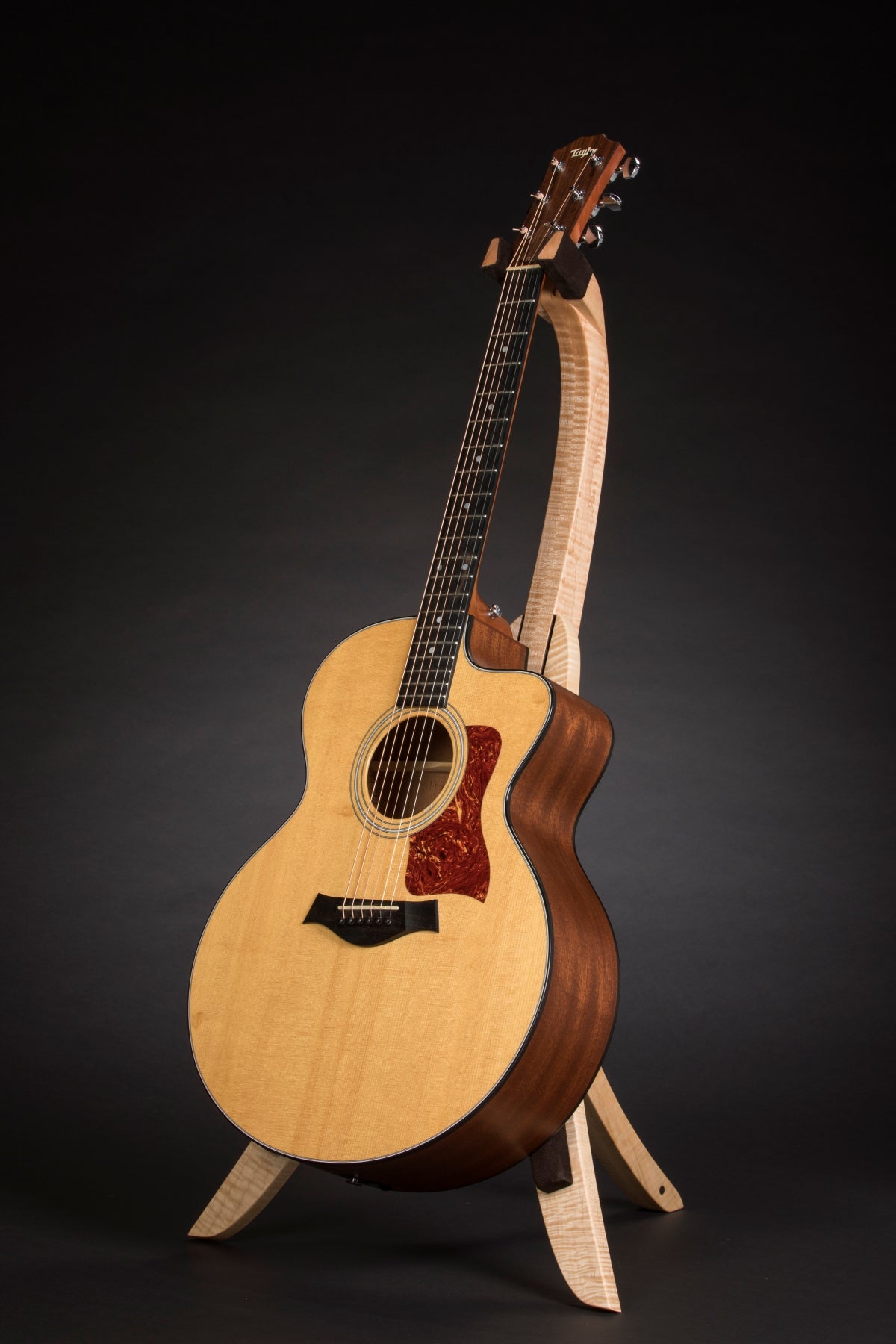 Folding curly maple wood guitar floor stand full front image with Taylor guitar