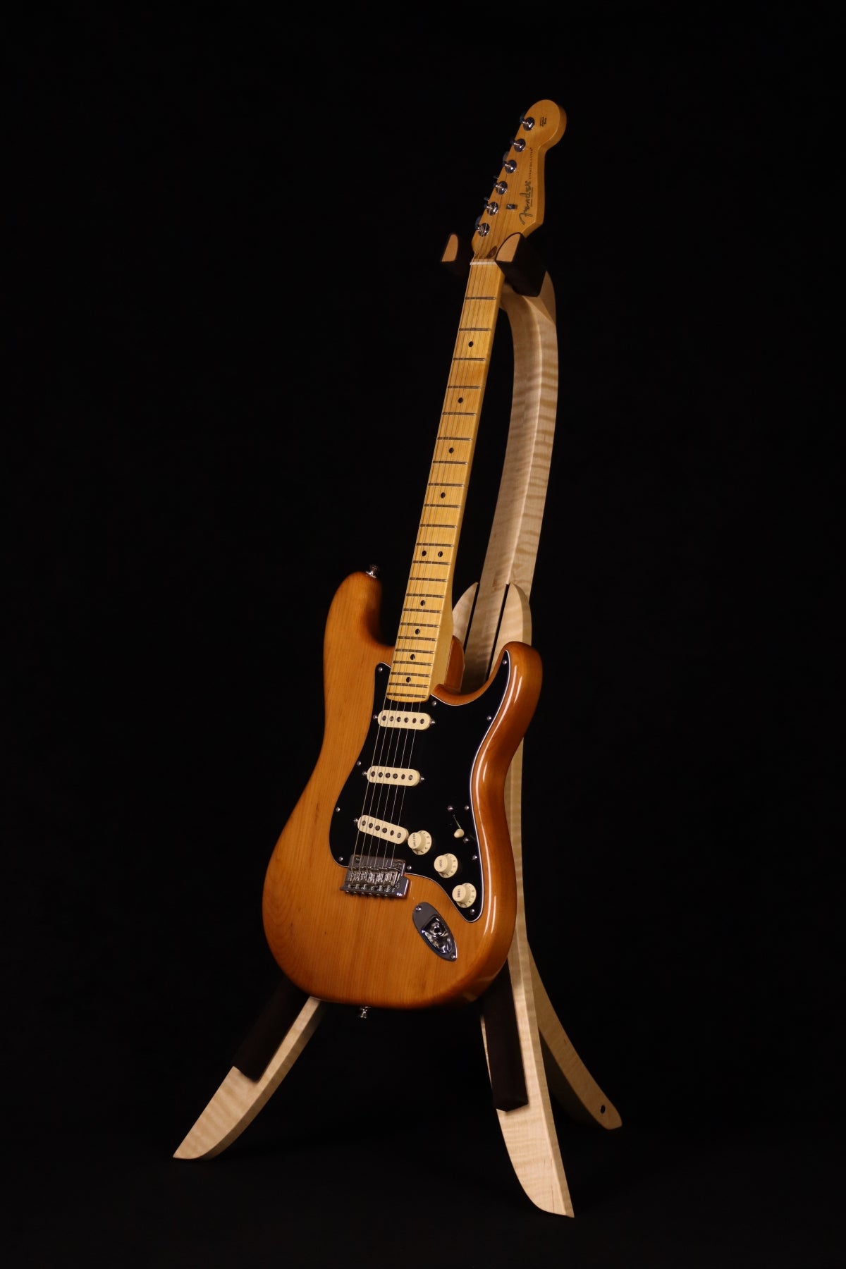 Folding curly maple wood guitar floor stand full front image with Fender guitar