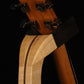 Folding curly maple and walnut wood guitar floor stand yoke detail image with Taylor guitar