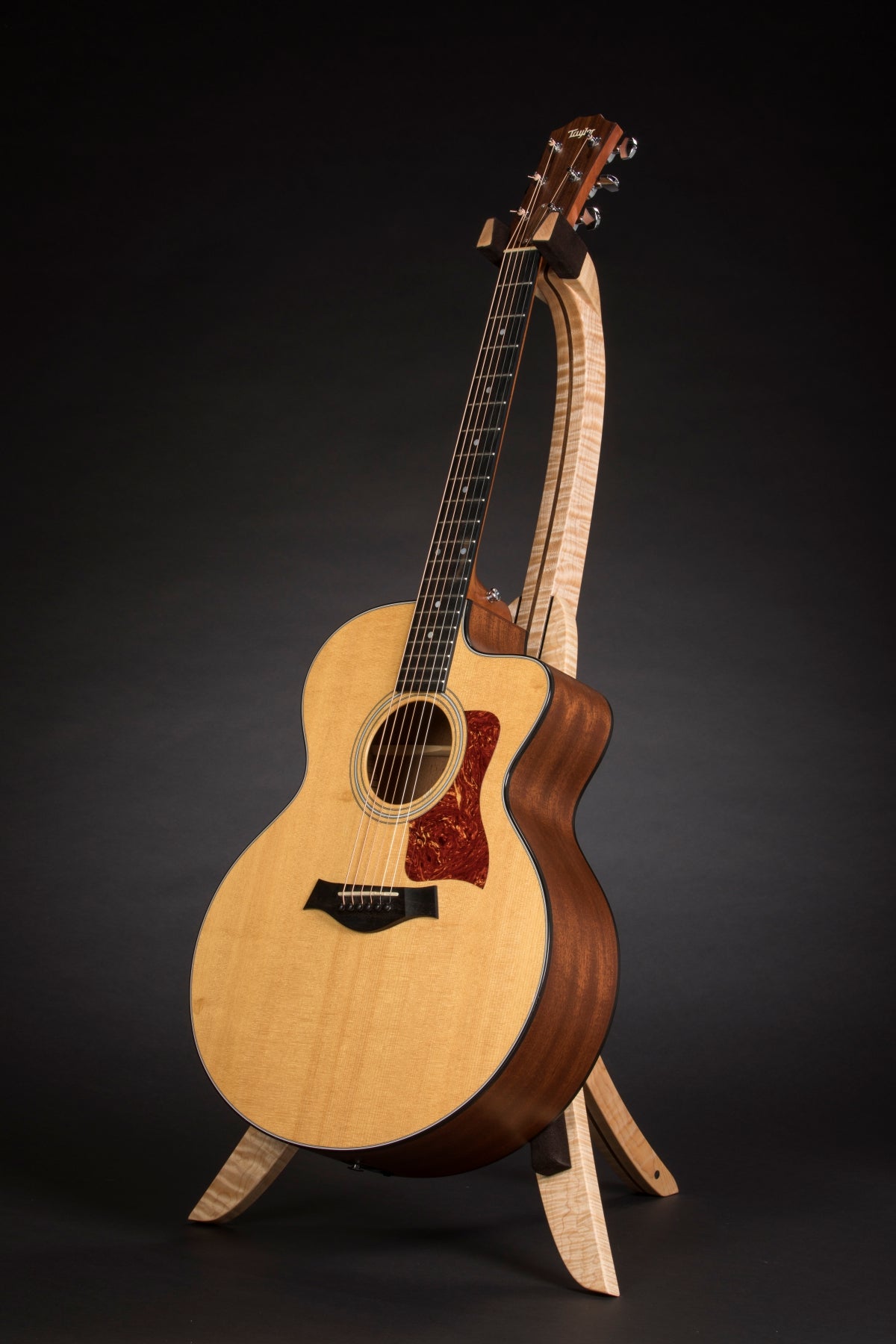 Folding curly maple and walnut wood guitar floor stand full front image with Taylor guitar