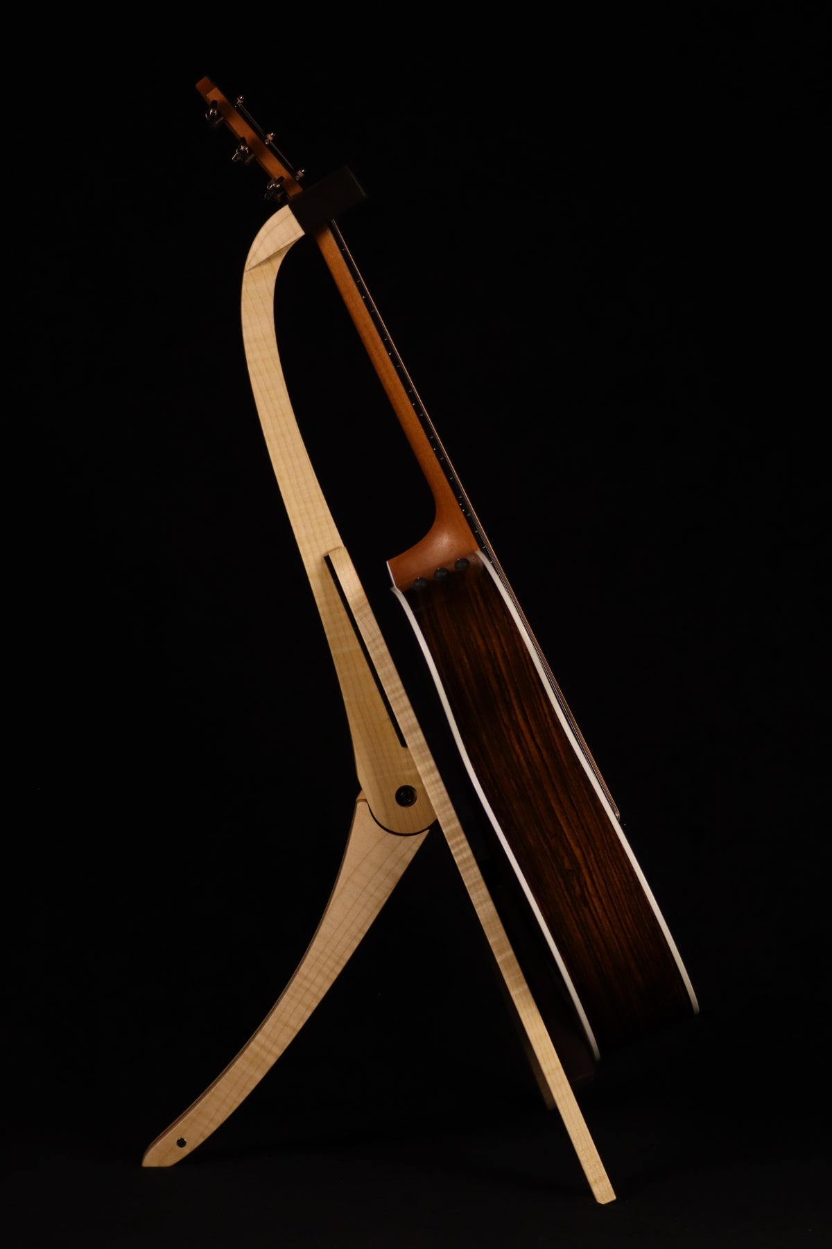 Folding curly maple and walnut wood guitar floor stand full side image with Taylor guitar