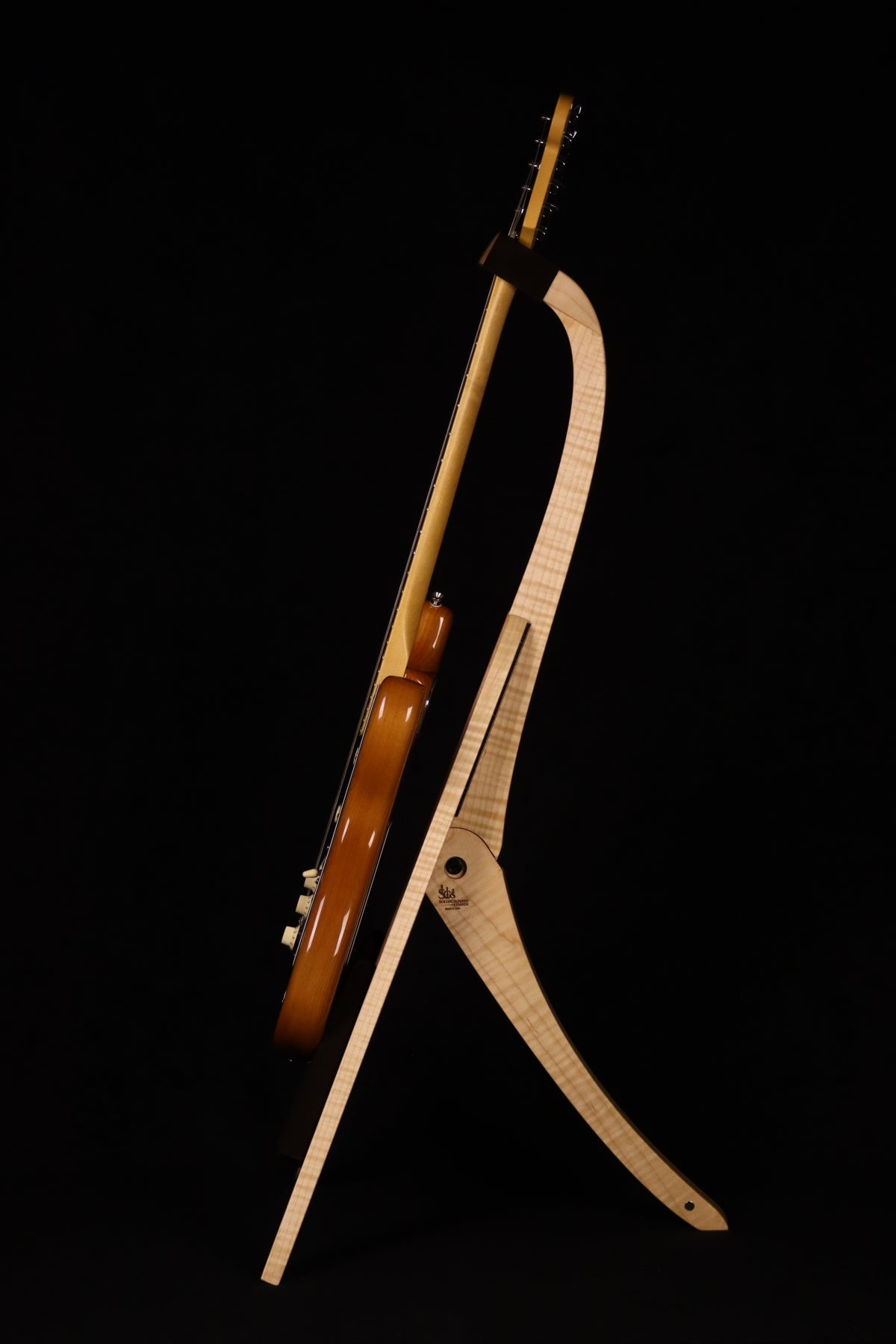 Folding curly maple and walnut wood guitar floor stand full side image with Fender guitar