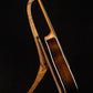 Folding chechen Caribbean rosewood and curly maple wood guitar floor stand full side image with Taylor guitar