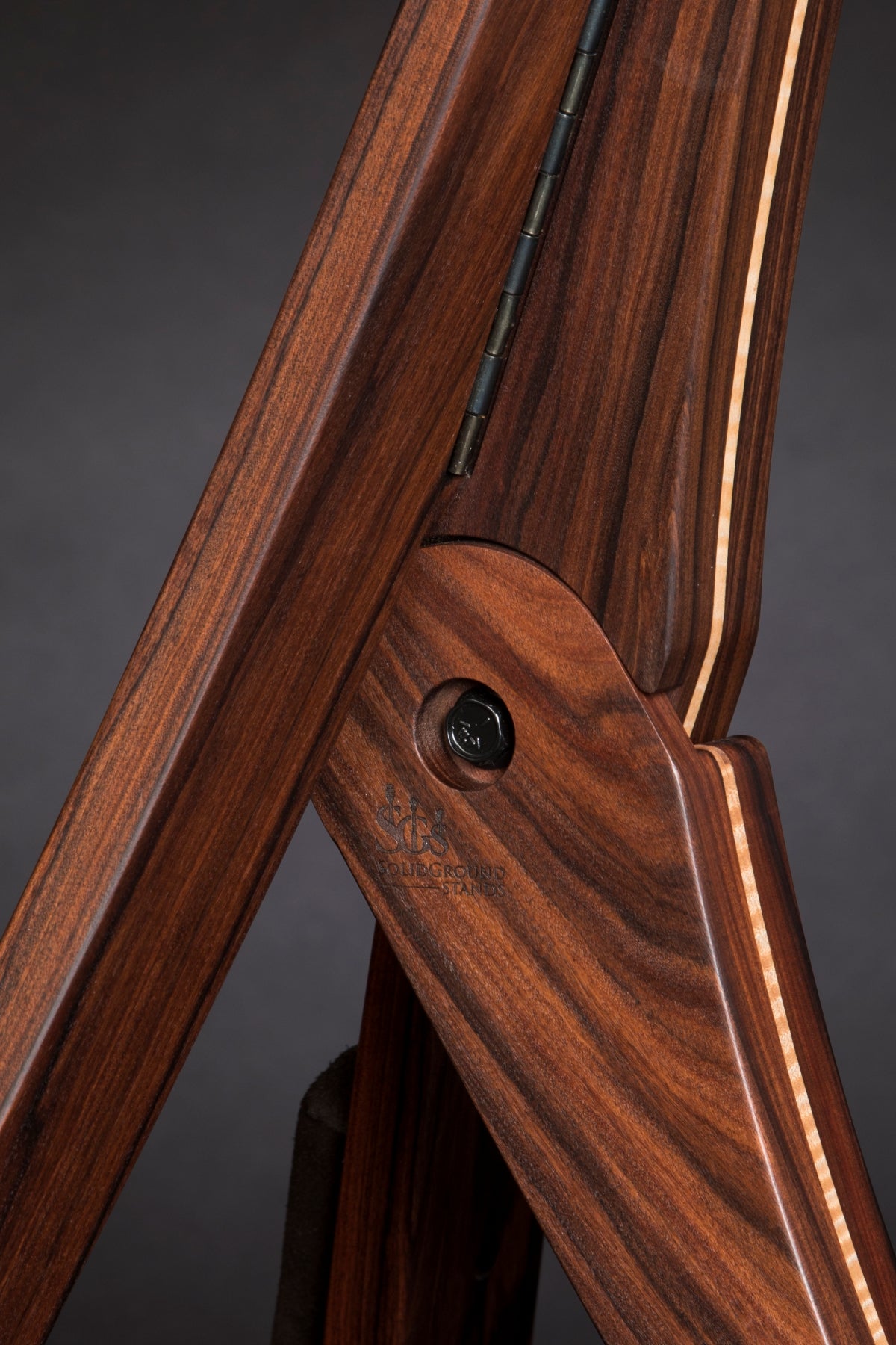 Folding morado Bolivian rosewood pau fero and curly maple wood guitar floor stand joinery detail image