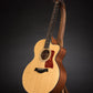 Folding walnut wood guitar floor stand full front image with Taylor guitar