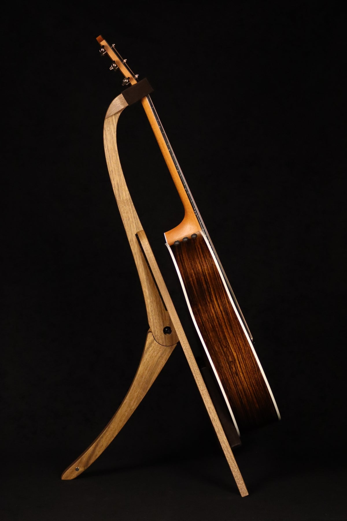 Folding walnut wood guitar floor stand full side image with Taylor guitar