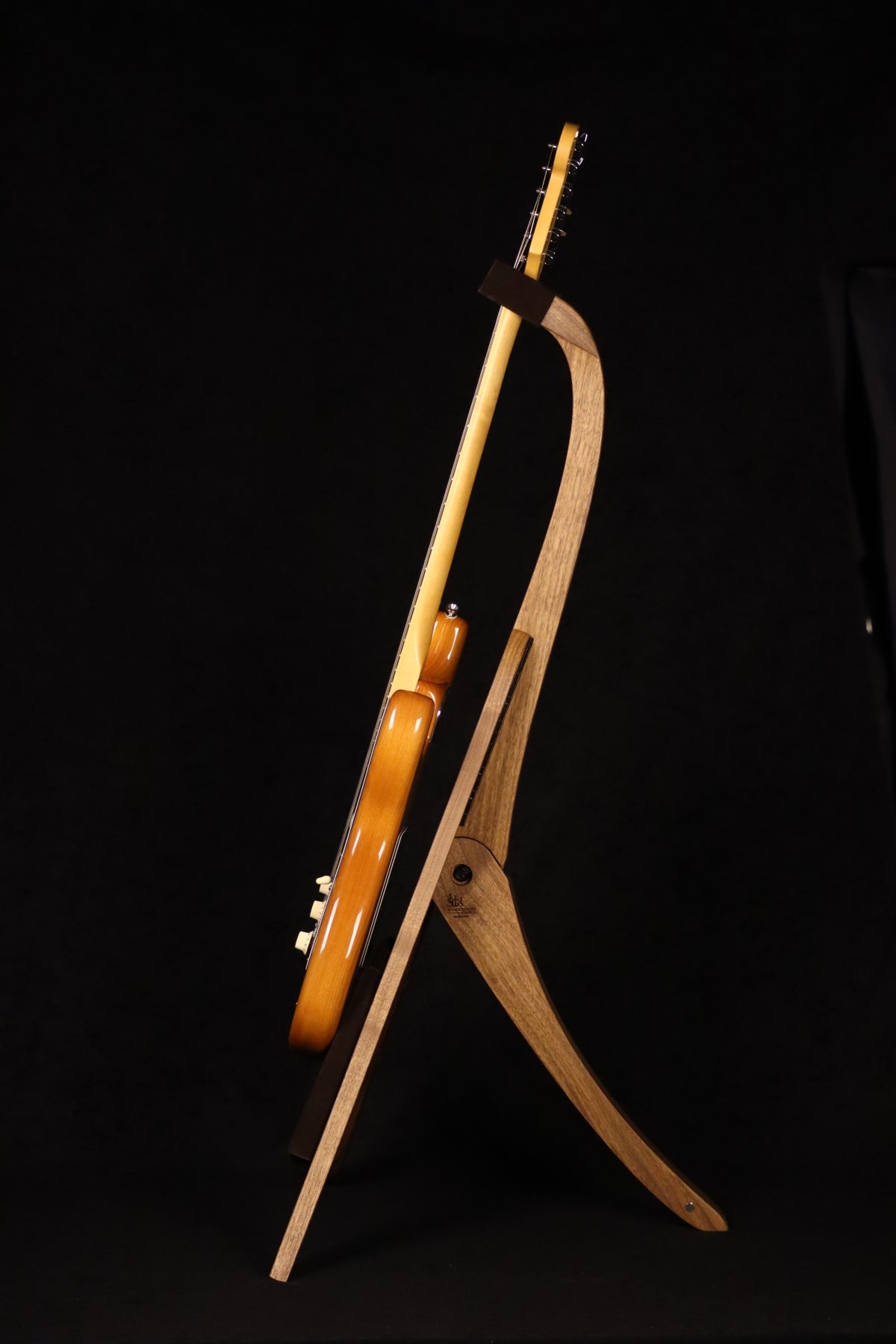 Folding walnut wood guitar floor stand full side image with Fender guitar