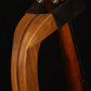 Folding cherry and walnut wood mandolin floor stand yoke detail image with Eastman mandolin