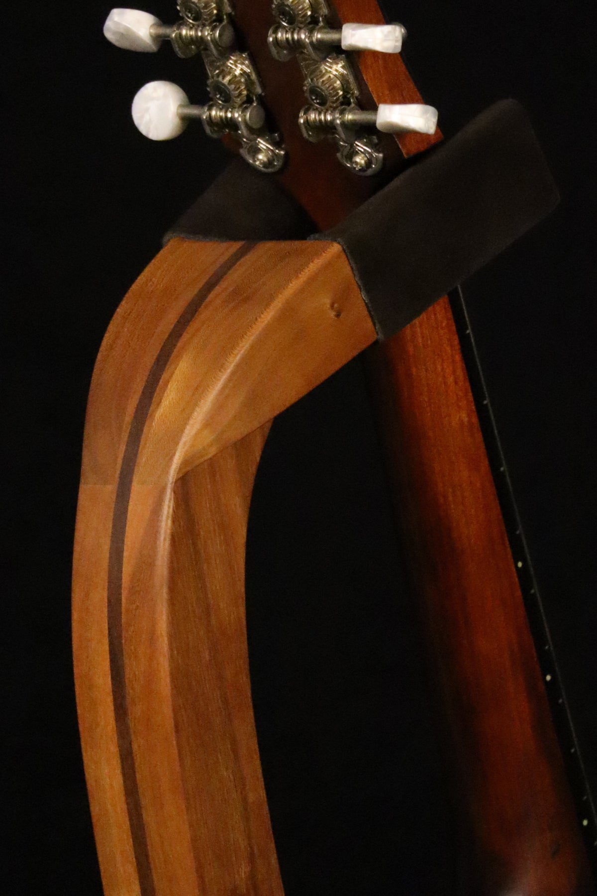 Folding cherry and walnut wood mandolin floor stand yoke detail image with Eastman mandolin