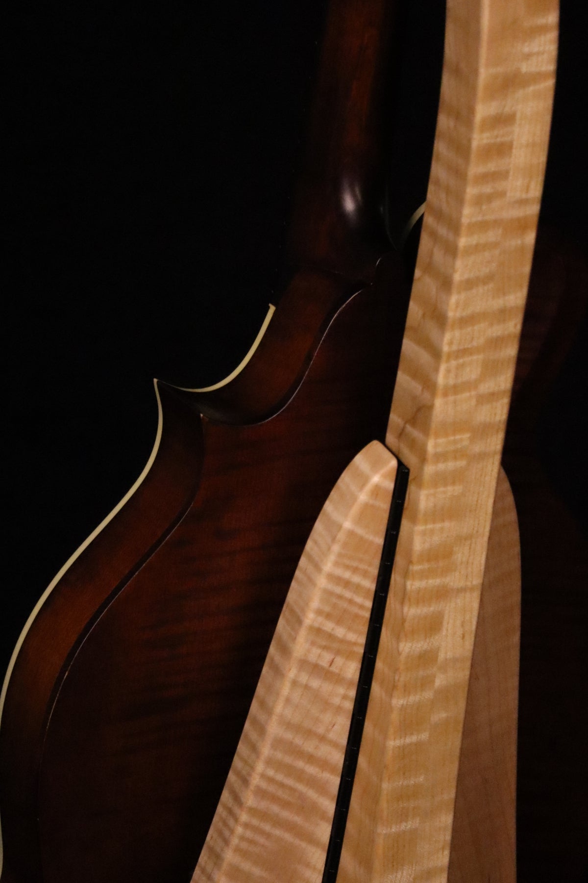 Folding curly maple wood mandolin floor stand closeup rear image with Eastman mandolin