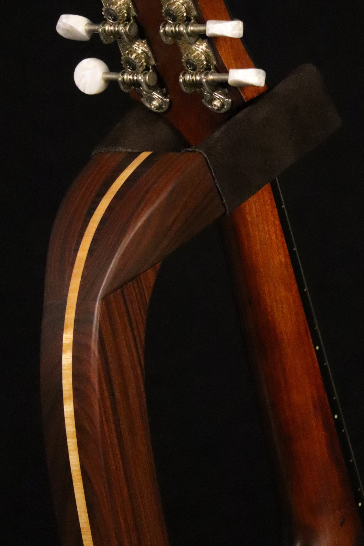 Folding morado Bolivian rosewood pau fero and curly maple wood mandolin floor stand yoke detail image with Eastman mandolin