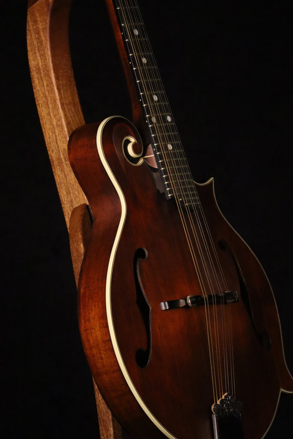 Folding sapele mahogany wood mandolin floor stand closeup front image with Eastman mandolin