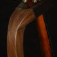 Folding walnut wood mandolin floor stand yoke detail image with Eastman mandolin