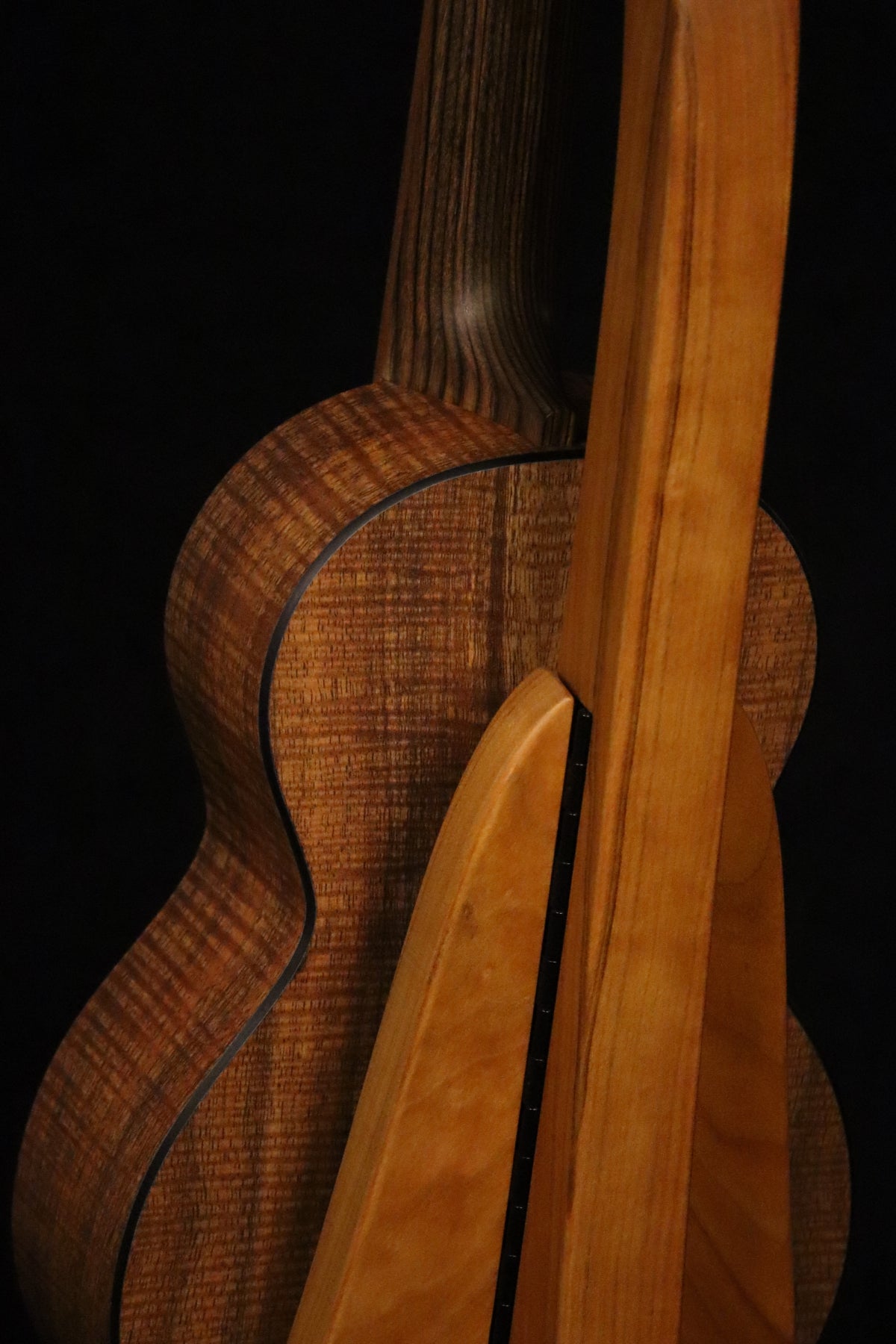 Folding cherry wood ukulele floor stand closeup rear image with Martin ukulele