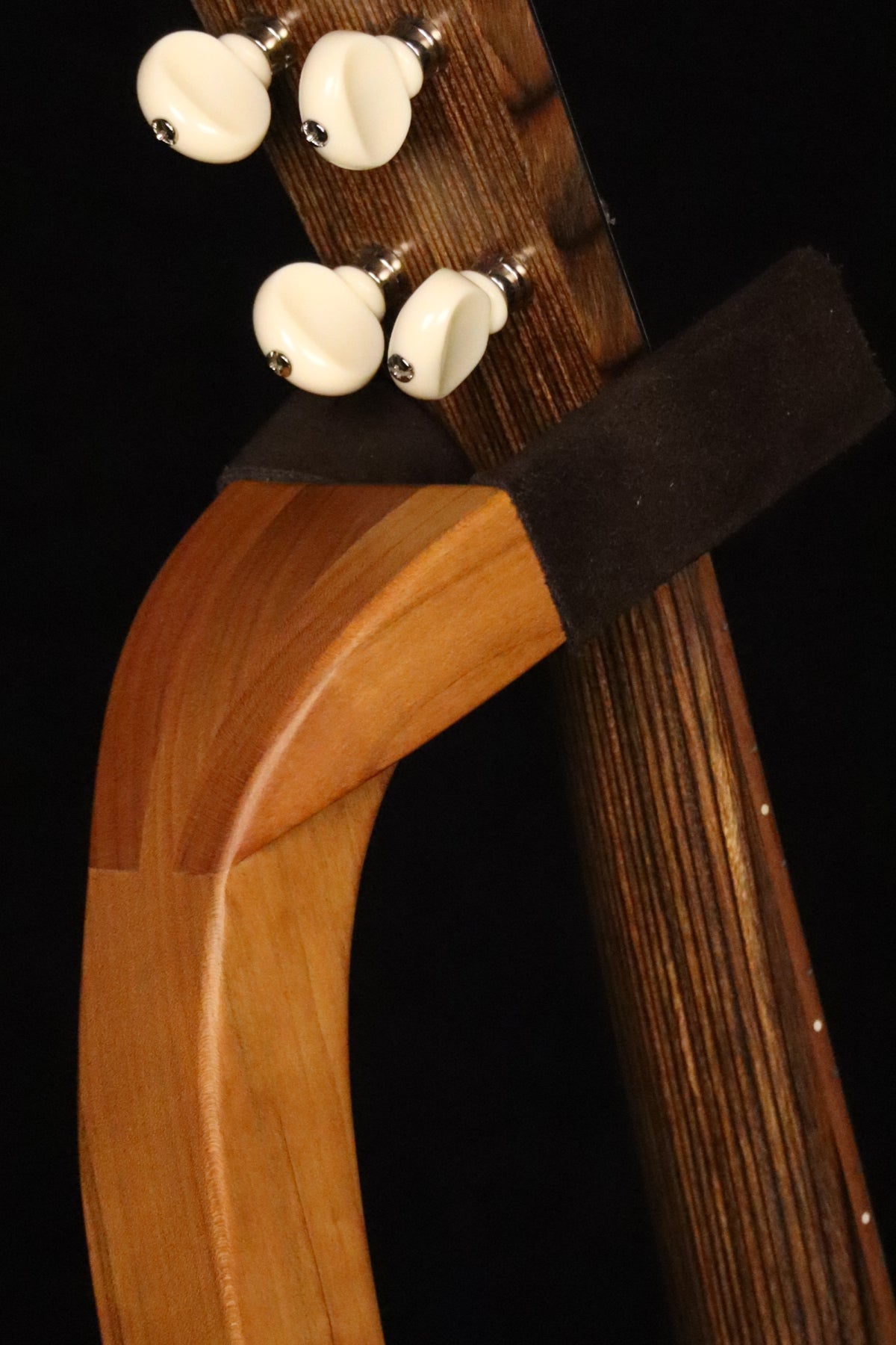Folding cherry wood ukulele floor stand yoke detail image with Martin ukulele