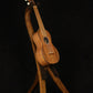 Folding walnut wood ukulele floor stand full front image with Martin ukulele
