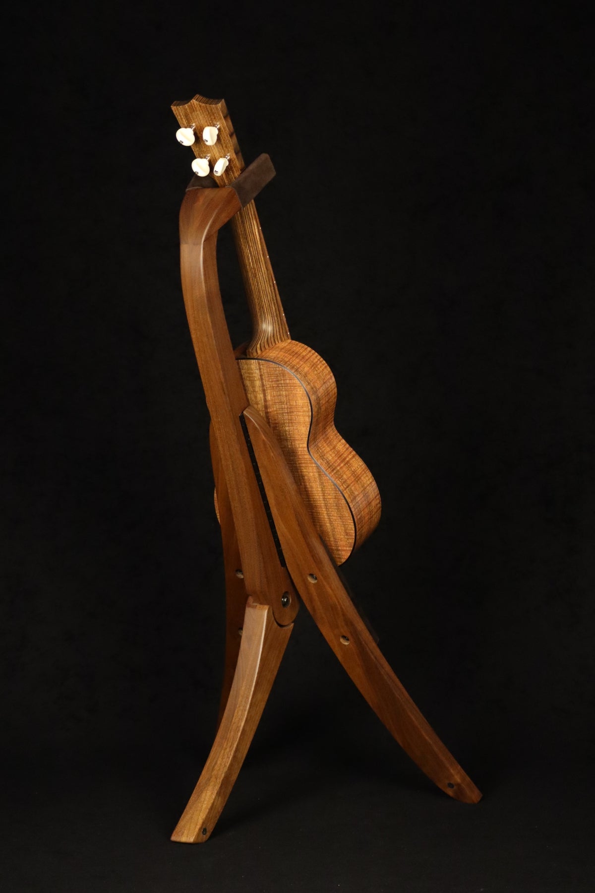 Folding walnut wood ukulele floor stand full rear image with Martin ukulele