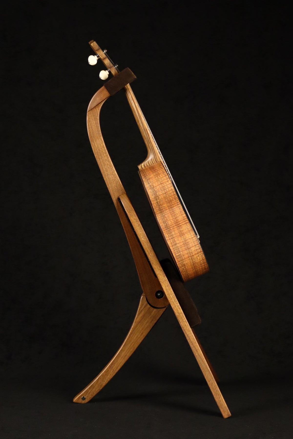 Folding walnut wood ukulele floor stand full side image with Martin ukulele