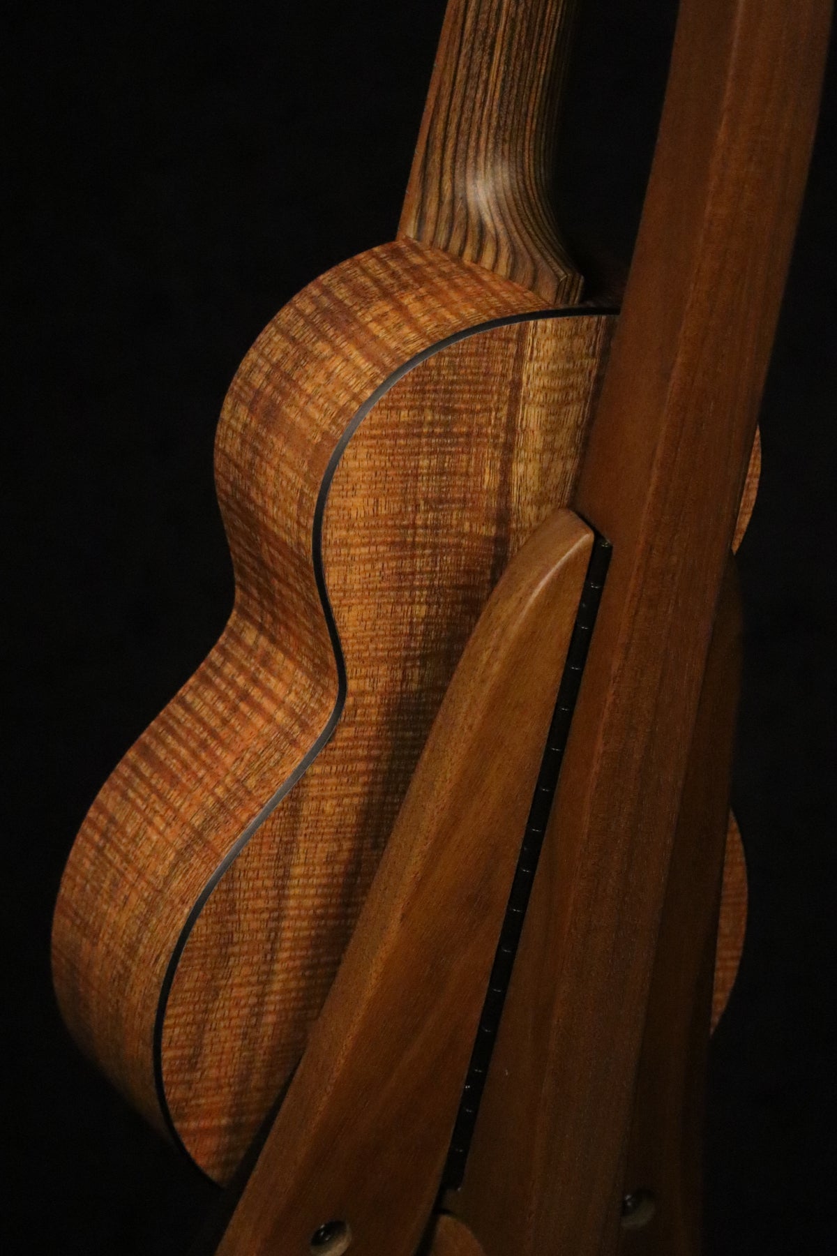 Folding walnut wood ukulele floor stand full rear image with Martin ukulele