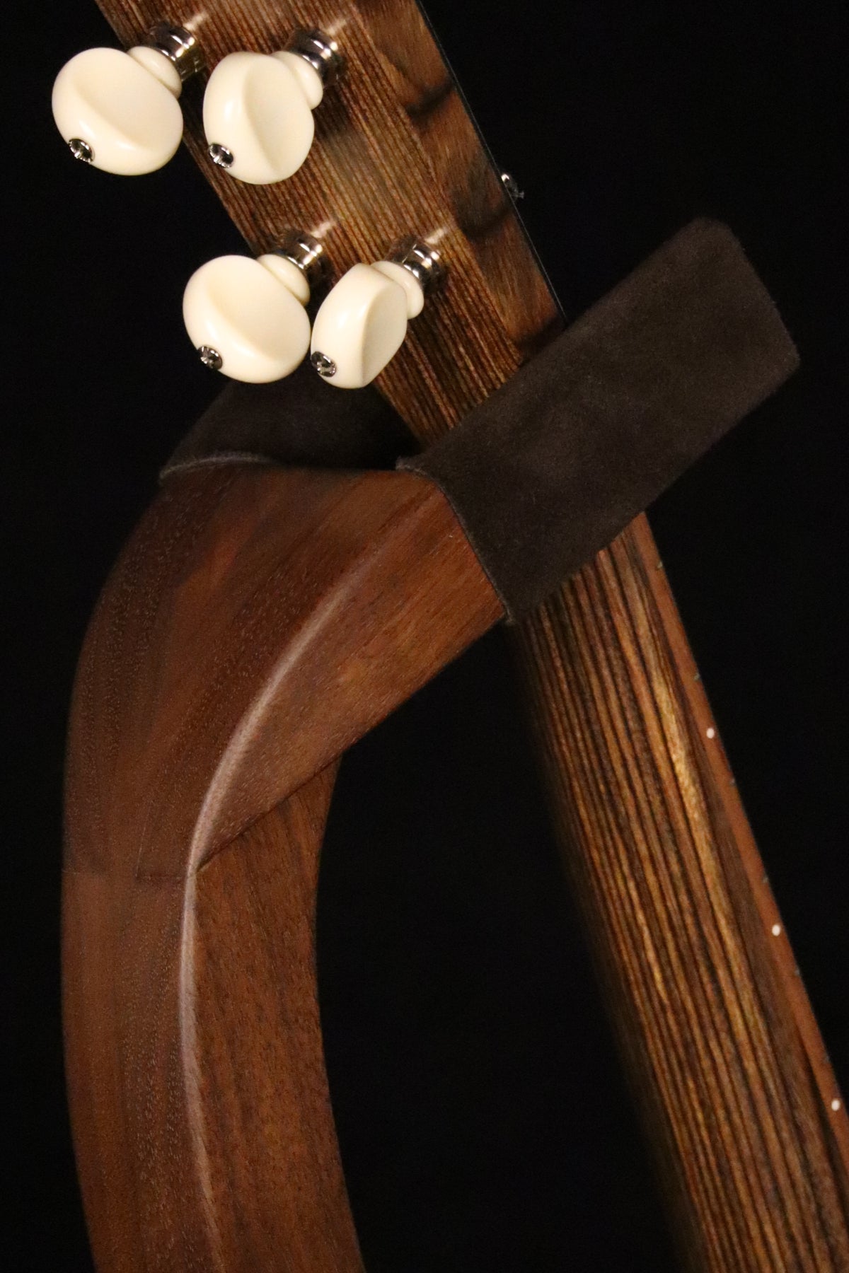 Folding walnut wood ukulele floor stand yoke detail image with Martin ukulele
