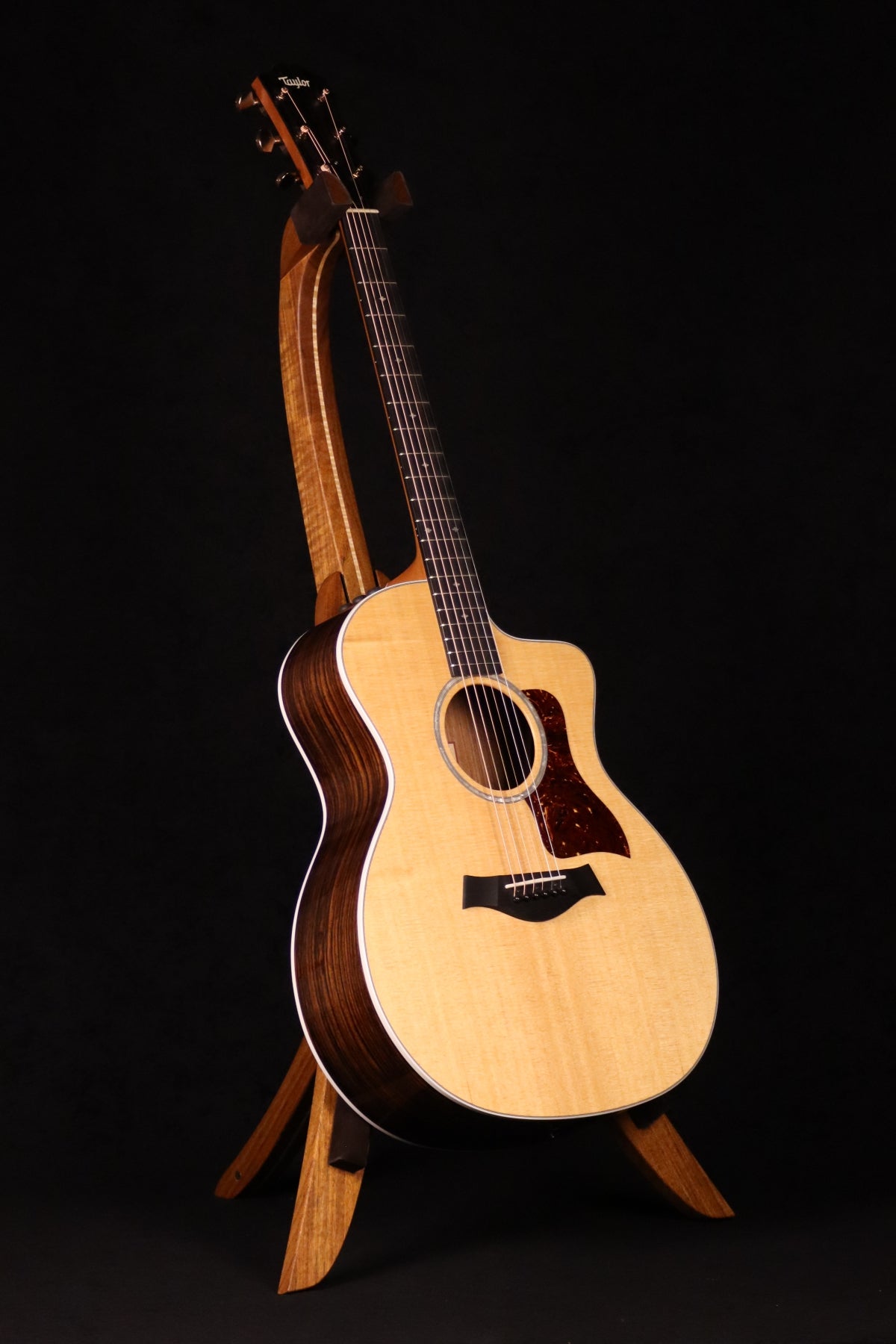 Folding sheuda ovangkol and curly maple wood guitar stand full front image with Taylor guitar
