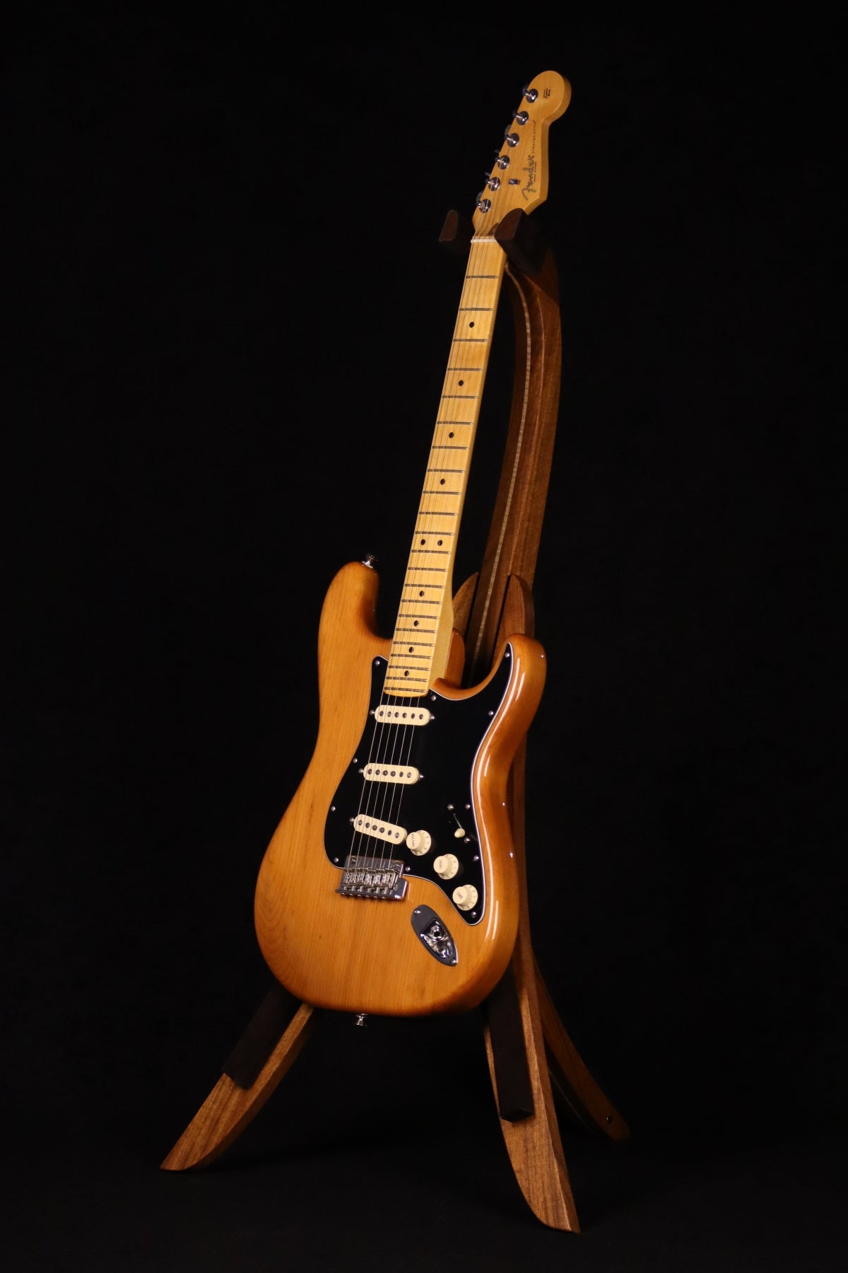 Folding sheuda ovangkol and curly maple wood guitar stand full front image with Fender guitar